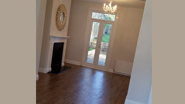 Through lounge with oak floor and fireplace