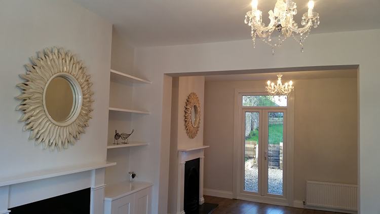 Reception room with period fireplace and alcove shelves