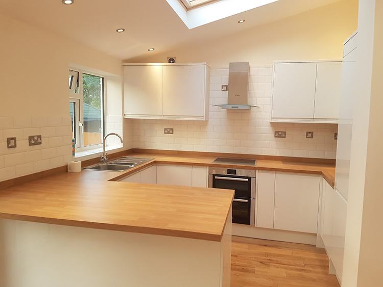 White gloss kitchen with oak worktops in the Oakdene Avenue extension