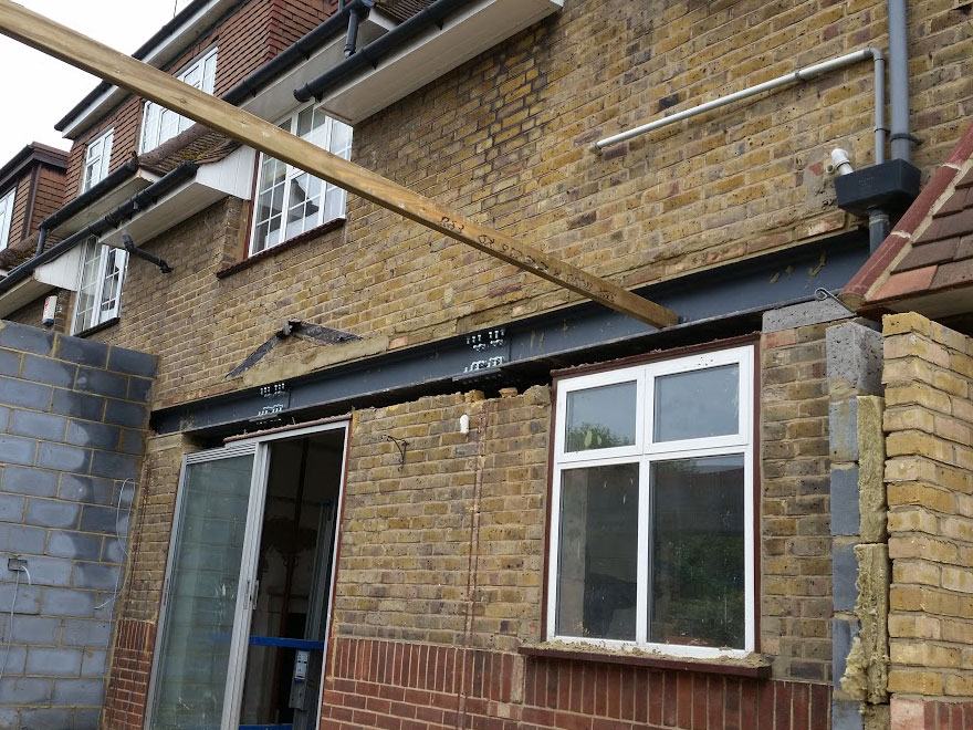 New steel beam installed across a rear opening