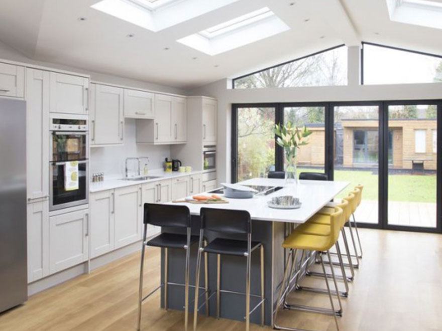 Open-plan kitchen with island and bi-fold doors